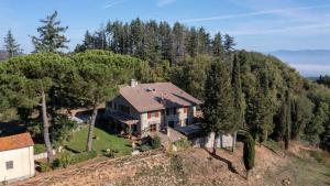 an aerial view of a house on a hill with trees at Montelucci Chianti Agrivilla in Gaiole in Chianti