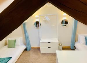 a room with two beds and a mirror at The Parlour in Hexham