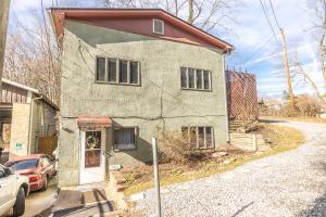 a house with a car parked in front of it at Relaxed Asheville Apartment - Pet-Friendly in Asheville