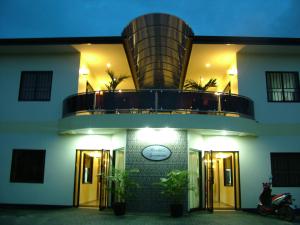 a building with a round balcony on top of it at Rachel's Apartments in Paramaribo