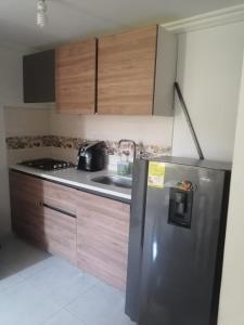 a kitchen with a stainless steel refrigerator and a stove at Lilia's House Santa Marta in Santa Marta