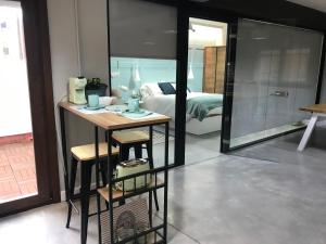 a room with a bed and a table and a mirror at Morriña Atlantica Loft in Pontevedra
