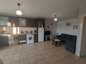 a large living room with a couch and a kitchen at Petra House in Petra