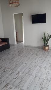a living room with a wooden floor and a flat screen tv at Rincón Joven II in San Miguel del Monte