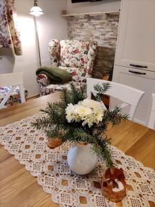 wazon z kwiatami na stole w salonie w obiekcie Slnečný dom w mieście Liptovské Revúce