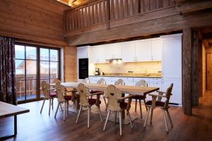 a kitchen and dining room with a table and chairs at Hotel Garni Ransburgerhof in Flachau
