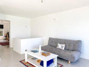 a living room with a couch and a coffee table at Palace Hill Apartment in Cape Town