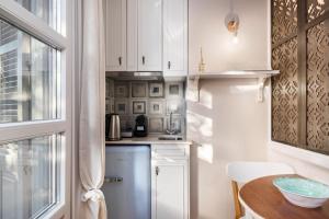 A kitchen or kitchenette at Well Apartments by Skyloft Corfu