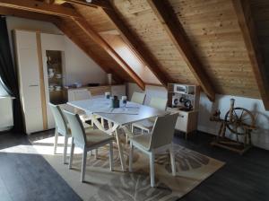 a kitchen and dining room with a table and chairs at Ti-Tó Apartman in Tihany