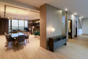 a dining room and living room with a table and chairs at Holiday Inn & Suites - Mexico Felipe Angeles Airport, an IHG Hotel in Zumpango de Ocampo