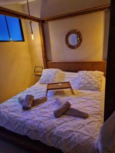 a bedroom with a bed with two pillows on it at Appartement - Spa in Monteux