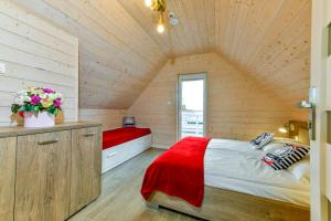 a bedroom with a large bed in a wooden house at Kotwisko in Sarbinowo +182 photos