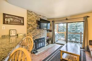 a living room with a fireplace and a table at Walk to Main St and Chairlift Breckenridge Condo! in Breckenridge