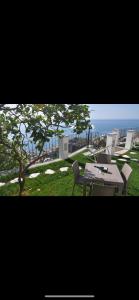 a table and chairs with the ocean in the background at Gresy Appartamento Suite in Positano