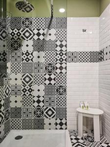 a bathroom with black and white tiles on the wall at Corso Italia Rooms in Milan