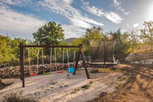 an empty swing set in a yard at Holiday home Srdašce in Perković