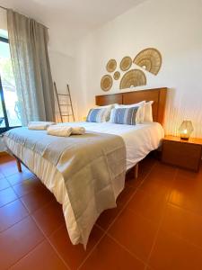 a bedroom with a large bed and a window at Residence Golf Club Vilamoura by Be Cherish in Quarteira