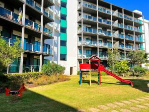 a playground in front of a apartment building at Residence Golf Club Vilamoura by Be Cherish in Quarteira