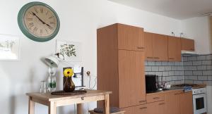 a kitchen with a table and a clock on the wall at Wohlfühlen in Neckarsulm in Neckarsulm