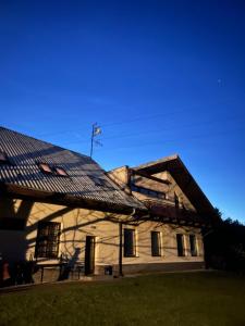 a house with a tin roof on top of it at Apartmán Brooklyn in Skalica