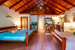 a bedroom with a bed and a living room at El Nido Jungle Lodge in Puerto Viejo