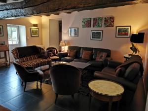 a living room with a couch and chairs at Le Petit Moulin in Faverelles
