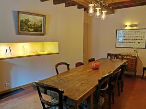 a dining room with a wooden table and chairs at Le Petit Moulin in Faverelles
