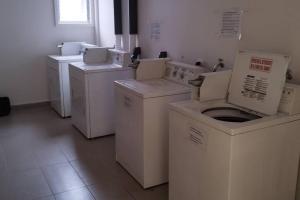 a row of washers and dryers in a room at Comfortable and quiet apartment. Pelluco Alto in Puerto Montt