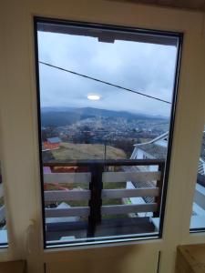 a window with a view of a city at Гостинний двір Матійчуків Новий in Vorokhta