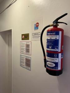 a fire extinguisher hanging on the wall of a room at Casa de Huéspedes Almansa in Madrid +105 photos
