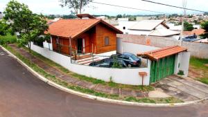 a house with a car parked in front of it at Casa em Brotas com Piscina e Churrasqueira in Brotas