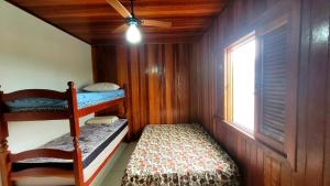 ein kleines Zimmer mit einem Etagenbett und einem Fenster in der Unterkunft Casa em Brotas com Piscina e Churrasqueira in Brotas
