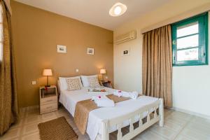 A bed or beds in a room at Alpha Stegna Sun