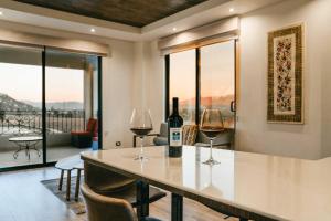 a kitchen with two glasses of wine on a counter at Villa Montefiori in Valle de Guadalupe