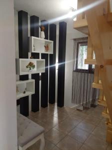 a living room with black and white striped walls at Casa Happy Family Bran in Bran
