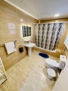 a bathroom with a toilet and a sink at The VIlla DUBAI in Dubai