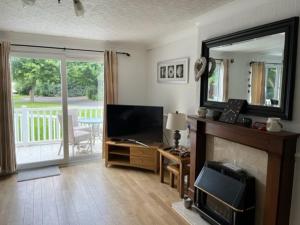 a living room with a television and a fireplace at Family Holidays Blackpool in Blackpool