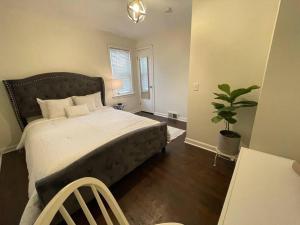 a bedroom with a large bed and a potted plant at New! Cozy 4-bedroom w/ free parking. Dogs welcome! in Berea