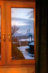 a view through a window of a winter scene at Apartament Stryszek Alpinistyczny in Bukowina Tatrzańska