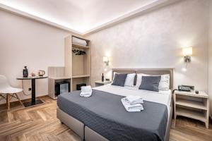 a bedroom with a large bed with towels on it at B&B Lorenzo de' Medici in Florence