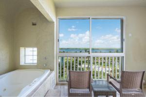 a bathroom with a tub and a large window at Club Regina Cancun in Cancún +13 photos