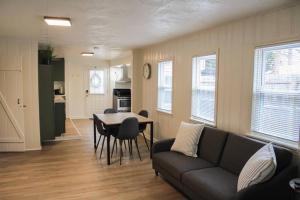 a living room with a couch and a table at New 1-bedroom Bungalow! 4 miles to CLE in Berea +17 photos