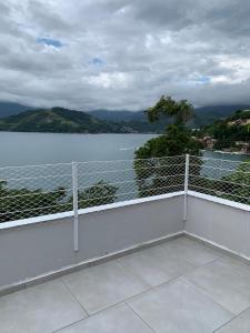 a balcony with a view of a body of water at Casa com Praia no quintal in Angra dos Reis