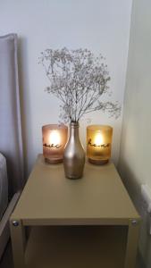 two candles sitting on top of a table with flowers at Pentadaktylos Mountain view apt 2 bedroom in Nicosia