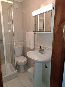 a bathroom with a sink and a toilet and a shower at Apartamento Mar e Sol in Gafanha da Nazaré