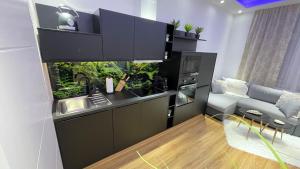 a kitchen with a fishtank in the middle of it at D&D Schönbrunner Deluxe Apartment in Vienna