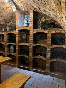 a room with a wall of wine bottles at Vinný sklípek U Františka in Dolní Bojanovice