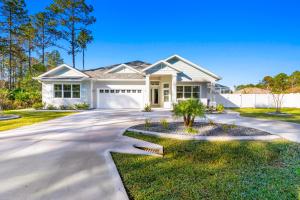 a white house with a driveway at Potomac Escape - Unit B in Palm Coast