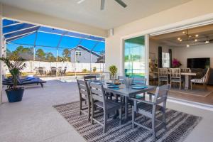 a dining room with a table and chairs at Potomac Escape - Unit B in Palm Coast