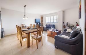 a living room and dining room with a table and chairs at Lovely Apartment In Las Lagunas De Mijas With Kitchen in Fuengirola